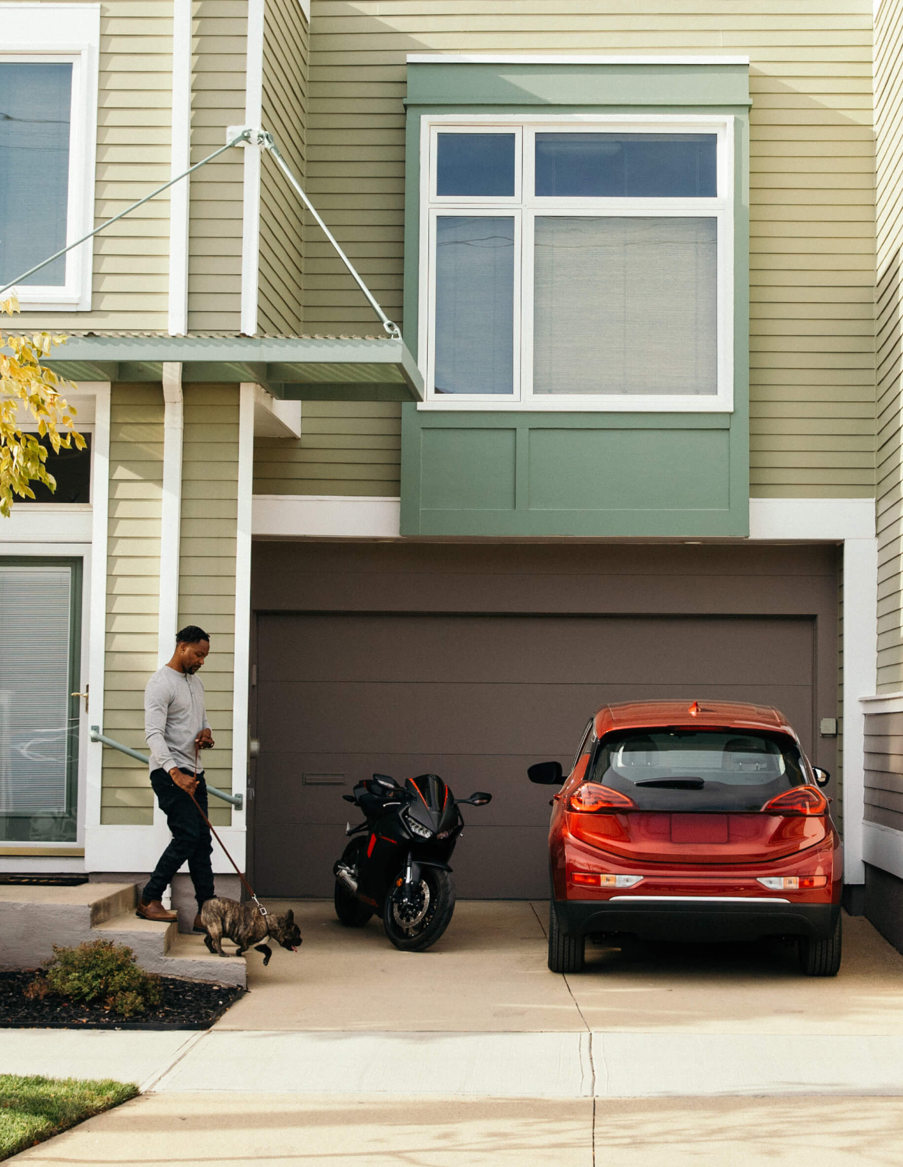 Man walking towards red car.