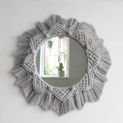 A beautiful macrame wall mirror, handmade using grey 4 ply macrame cotton cord.