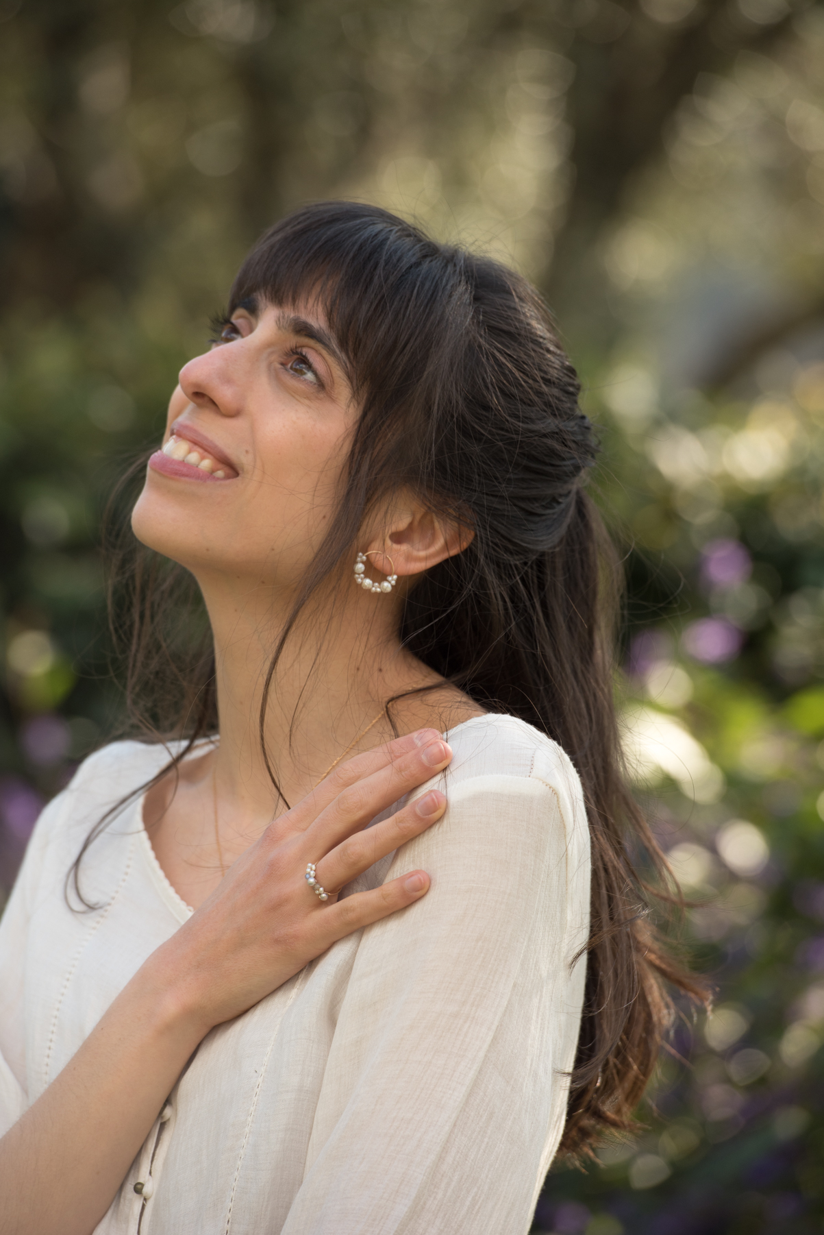 A photo of a model wearing statement pearl earrings from the brand mamie coco atelier