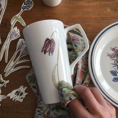 applying ceramic tranfsers of my illustrations to Latte mugs