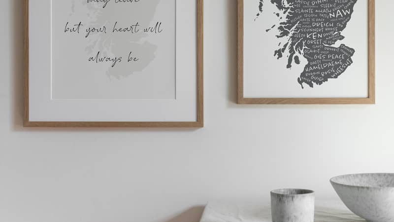 An image of two different map of Scotland prints on a wall