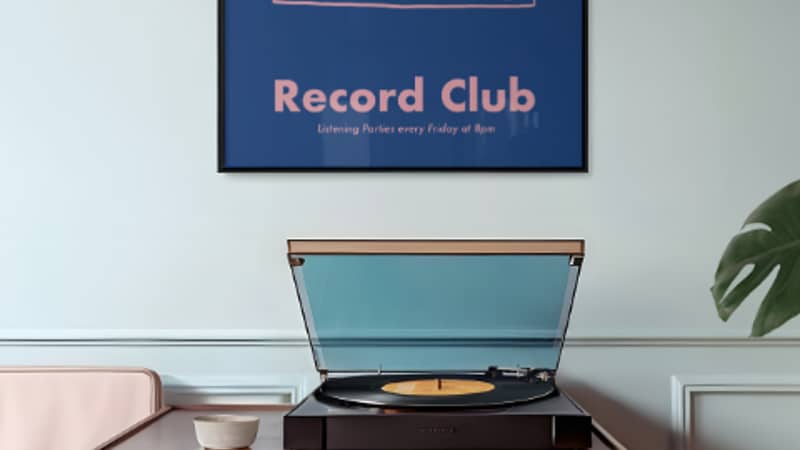 Record Club print hung on a wall above a record player