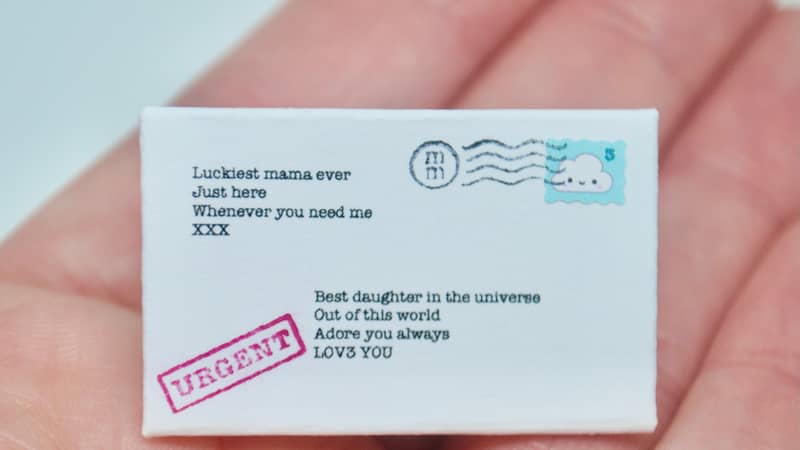 Tiny letter in a hand