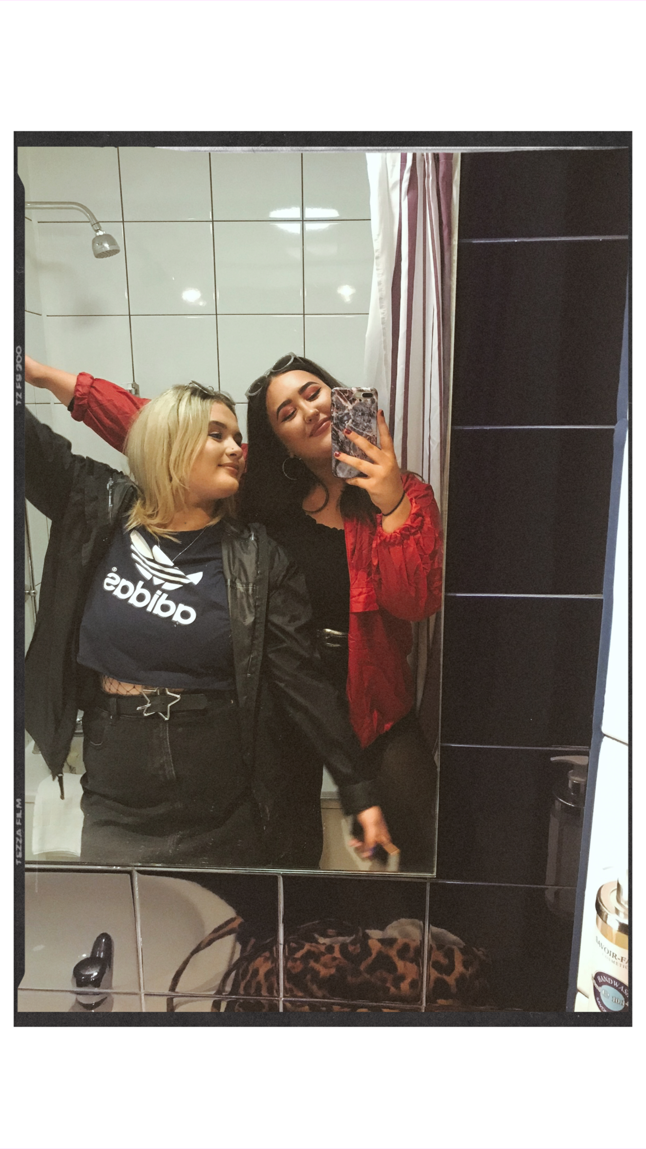 Two girls stood in mirror 