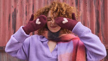 Girl wearing mittens with heart detail