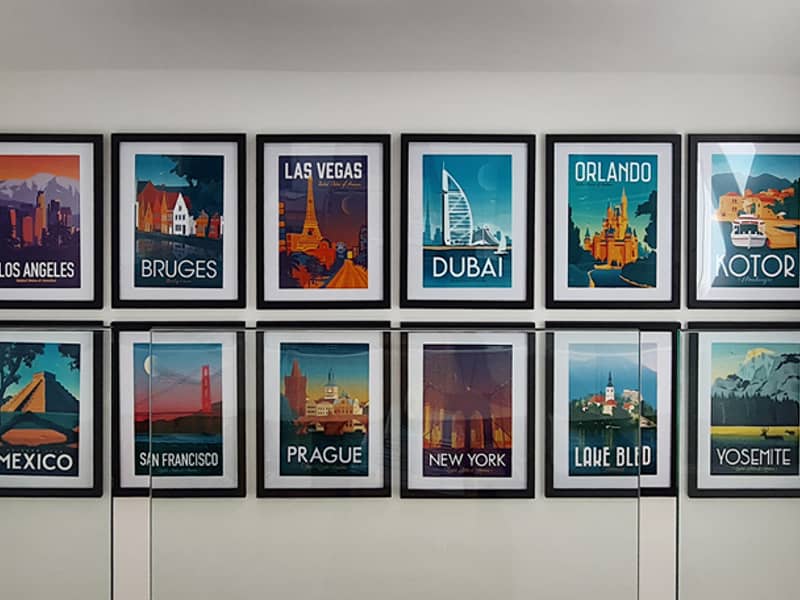 Gallery wall featuring travel poster collection
