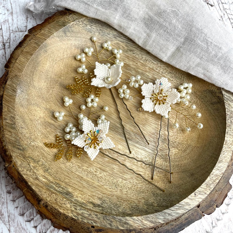 A set of three hand beaded floral hairpins