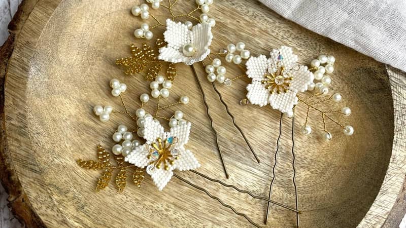 A set of three hand beaded floral hairpins