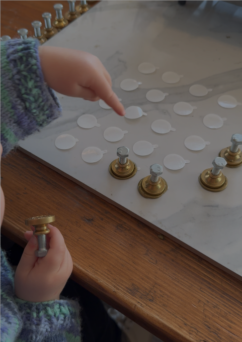 a 2 year old making wax seals 