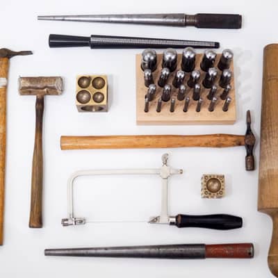 traditional jewellery making tools played out on white background