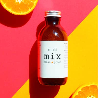 Multi purpose eco cleaning zero waste plastic free on pink and yellow background with orange at edges to show organic sweet orange oil used