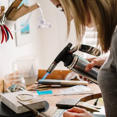 Gemma soldering a bangle at the workbench