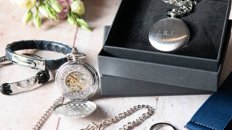 Pocket watch, leather bracelet, tie slide & key ring.