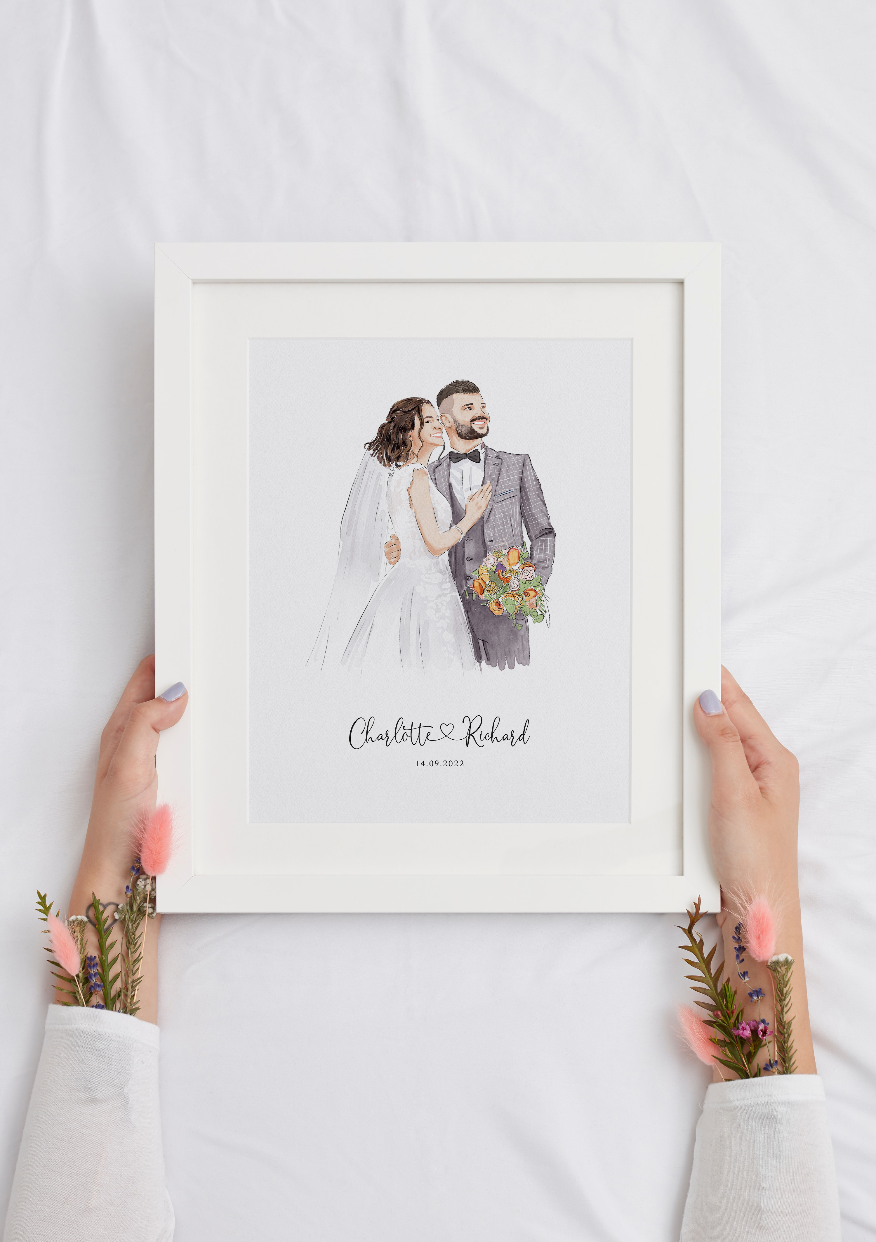 A personalized wedding portrait featuring a couple in elegant attire, held in a white frame.