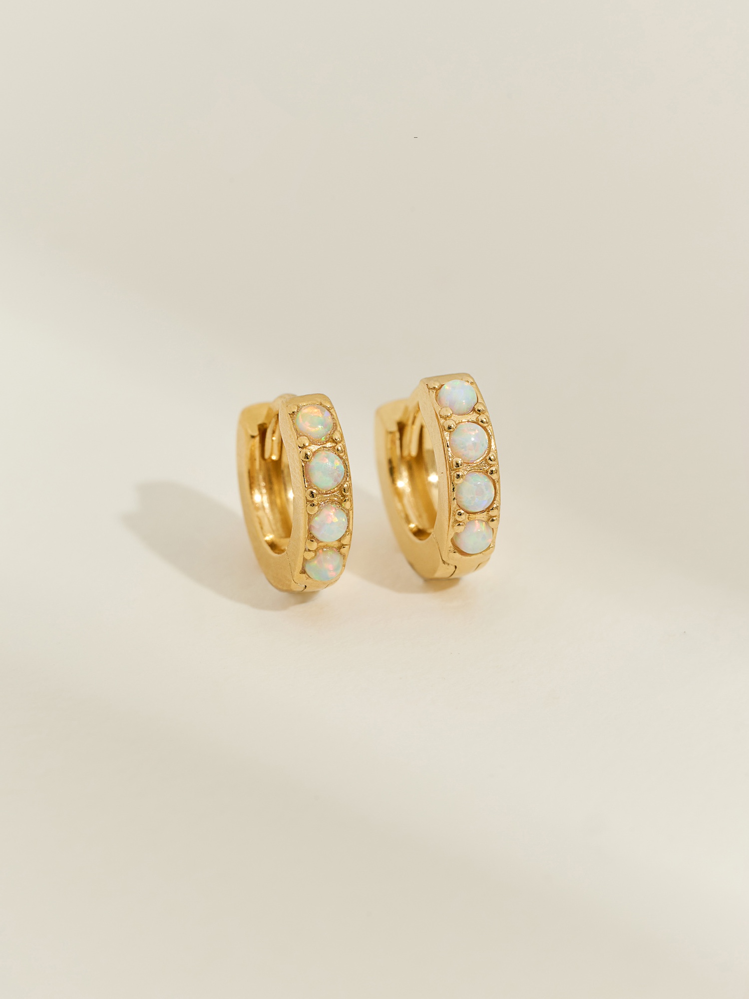 Gold opal huggies 