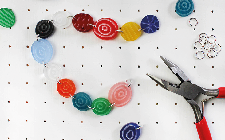 Colourful necklace and pliers