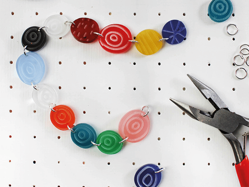 Colourful necklace and pliers