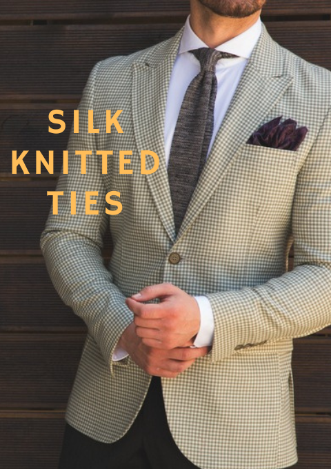 Male model wearing a light check suit and black tie