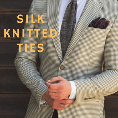 Male model wearing a light check suit and black tie