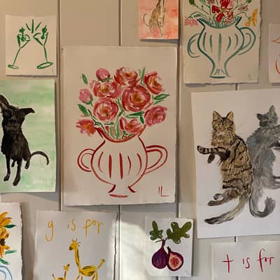 Gallery wall showing red flowers in a vase