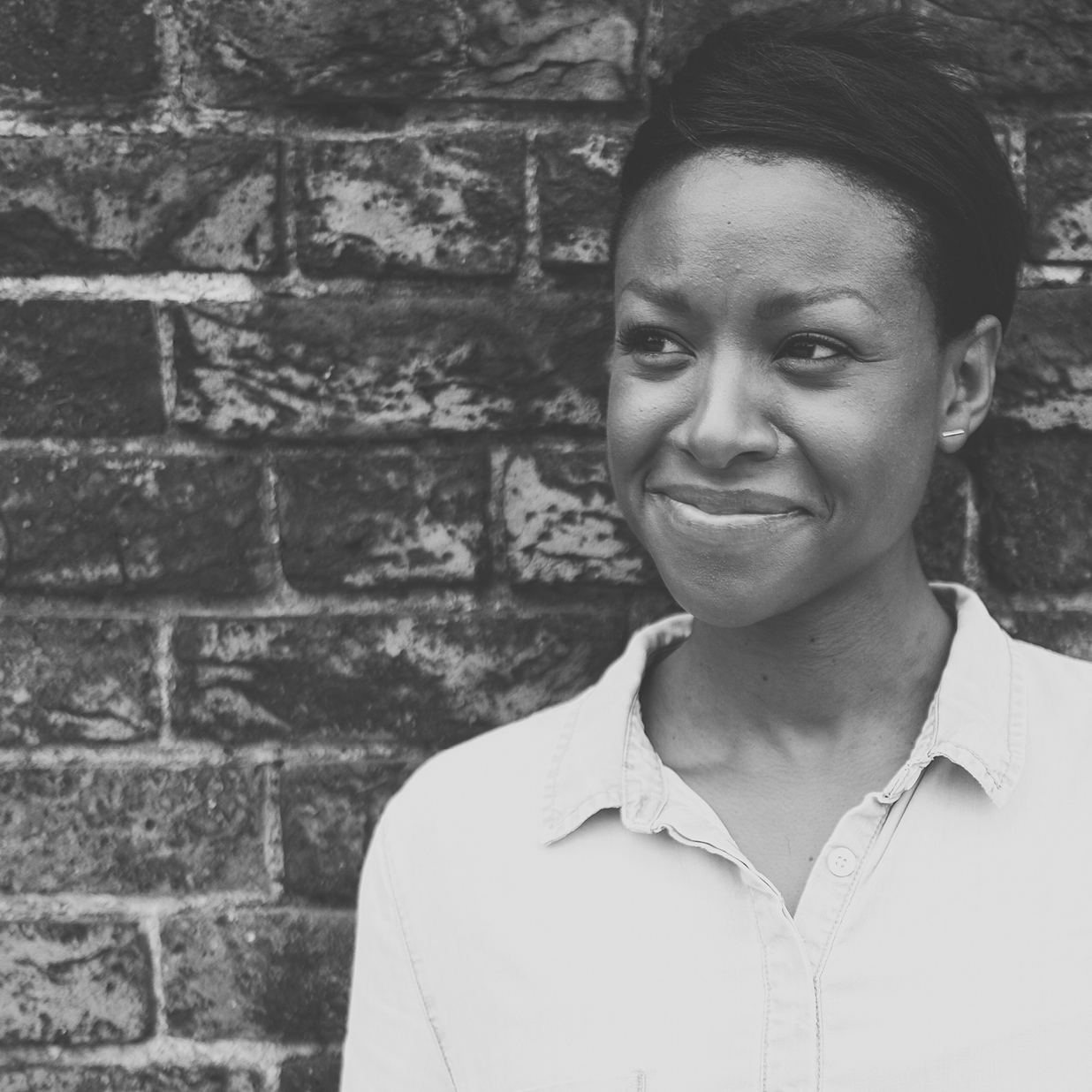 A hand holding a print from the Fiona's Notes collection. The print is an illustrated house on a sage green bacground