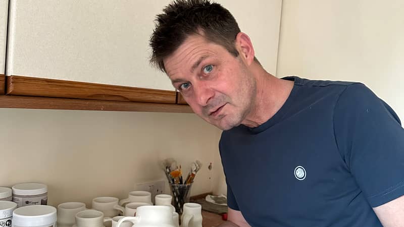 Getting the mugs ready for the first firing in the kiln