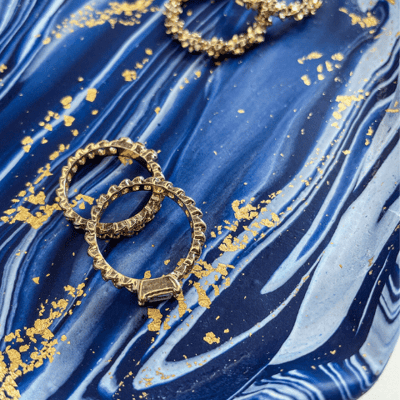 blue marble jewellery tray with rings and hoop earrings