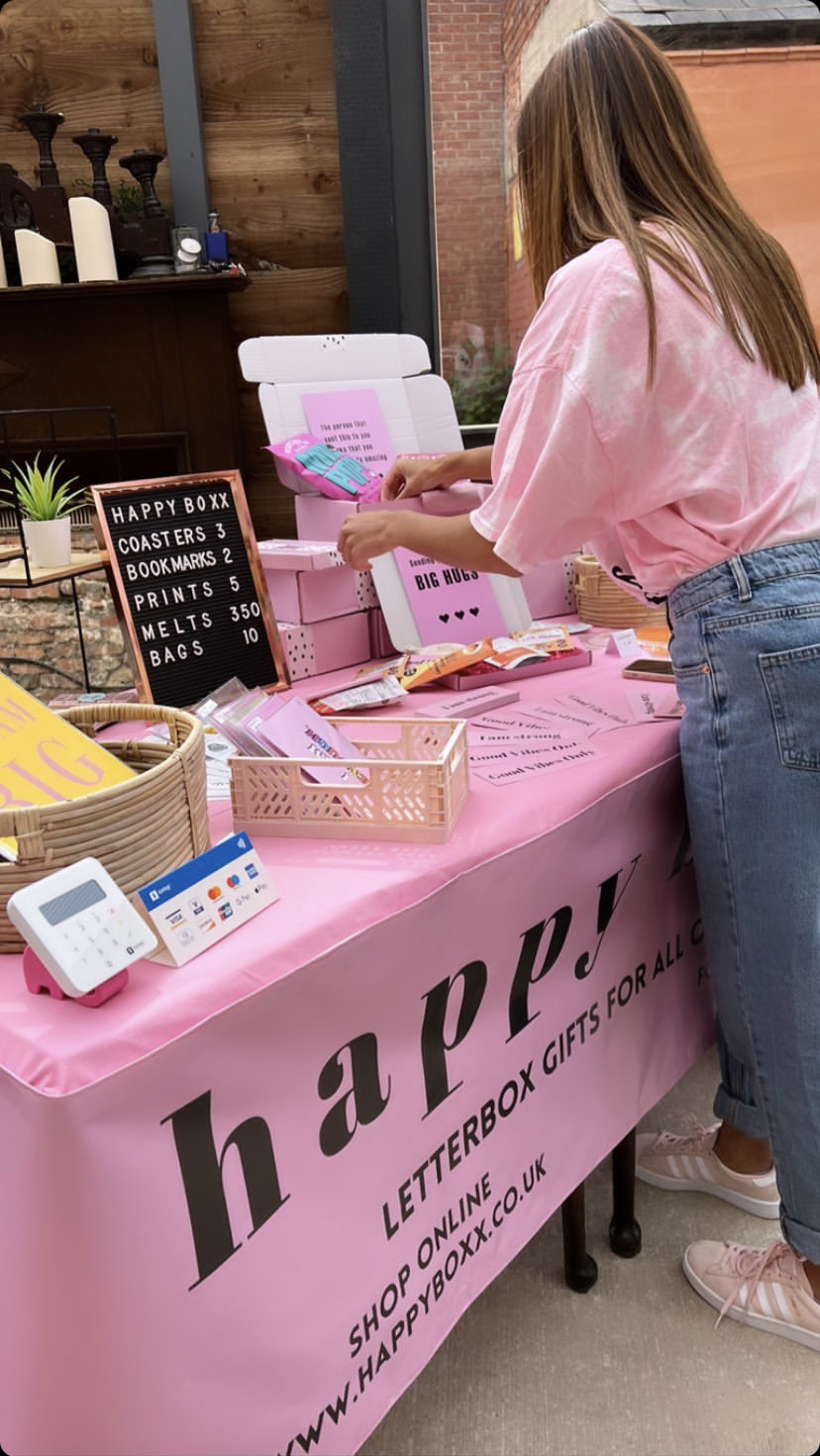 Image of Market Stall setup with Happy Boxx banner and products displayed