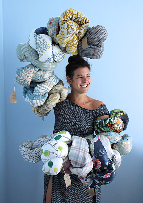 Adonia holding Mini Squish Knot Cushions