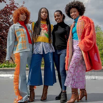 Image of Tihara Smith with three models wearing her Windrush collection