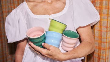 hand holding colourful cups