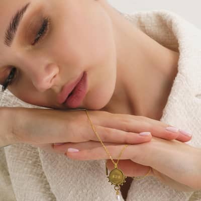 Thick gold statement ring with gold coin choker and necklaces