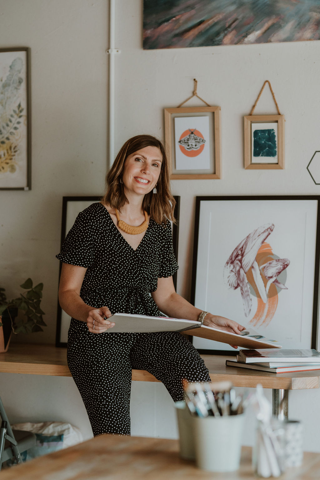 Image of Kirsty Hall with her art work. 