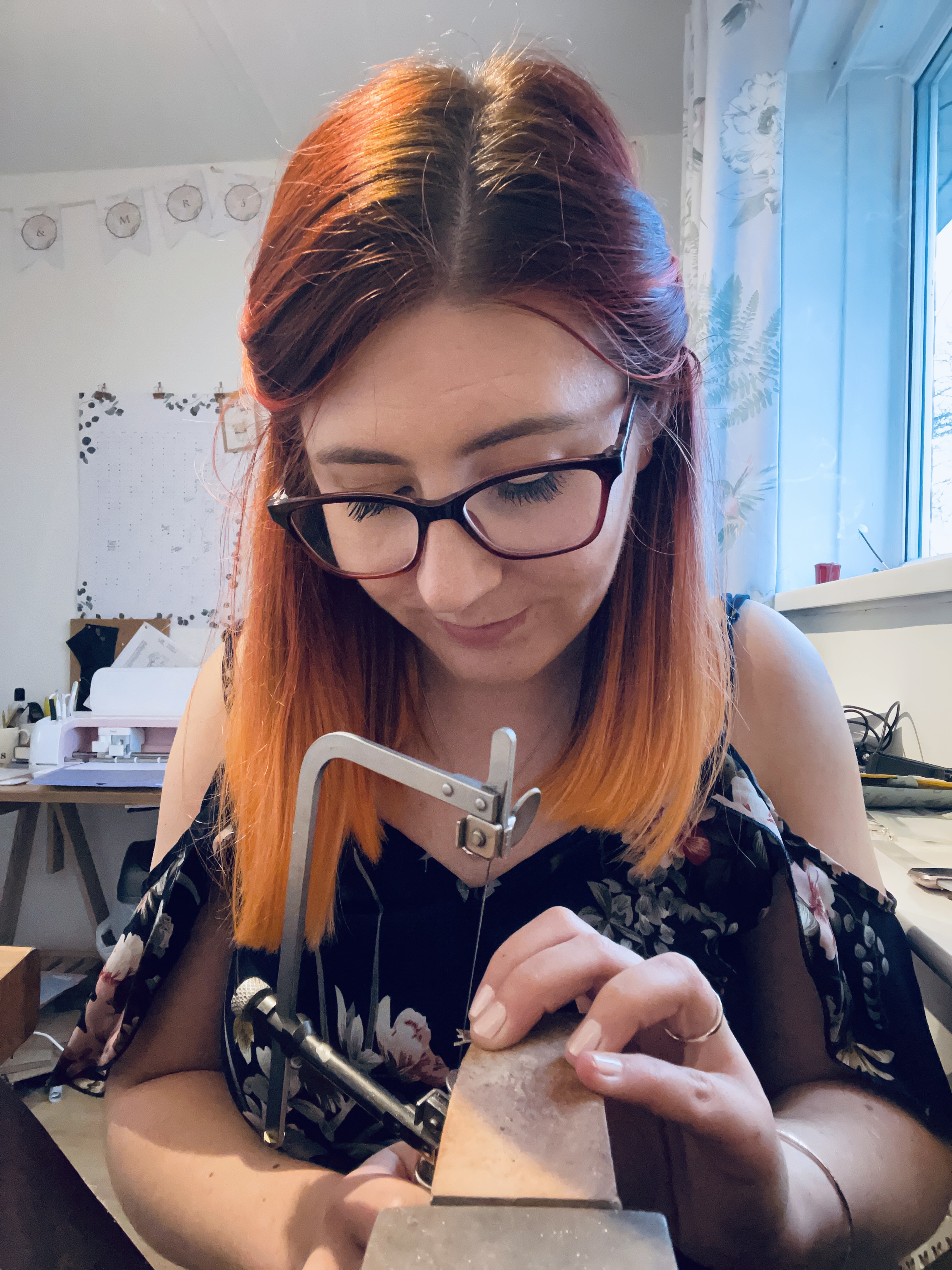 Jen Lithgo - Jen sat at the jeweller's peg, piercing leaves out of sterling silver sheet