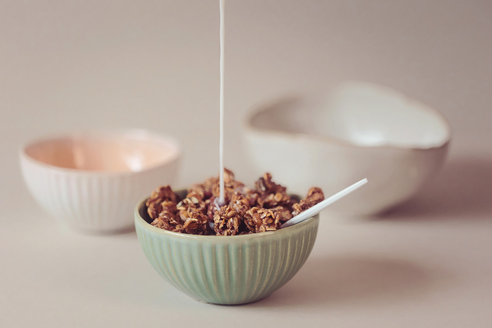  Granola in a bowl with milk being poured in