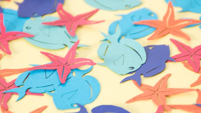 Under the Sea themed paper table confetti with fish and starfish