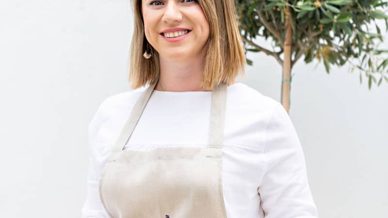 Soapmaker holding a tray of soaps