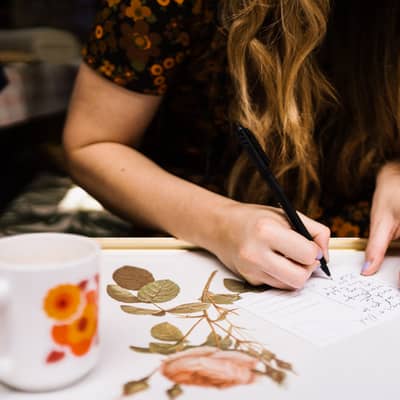 Katie handwriting customer postcards.