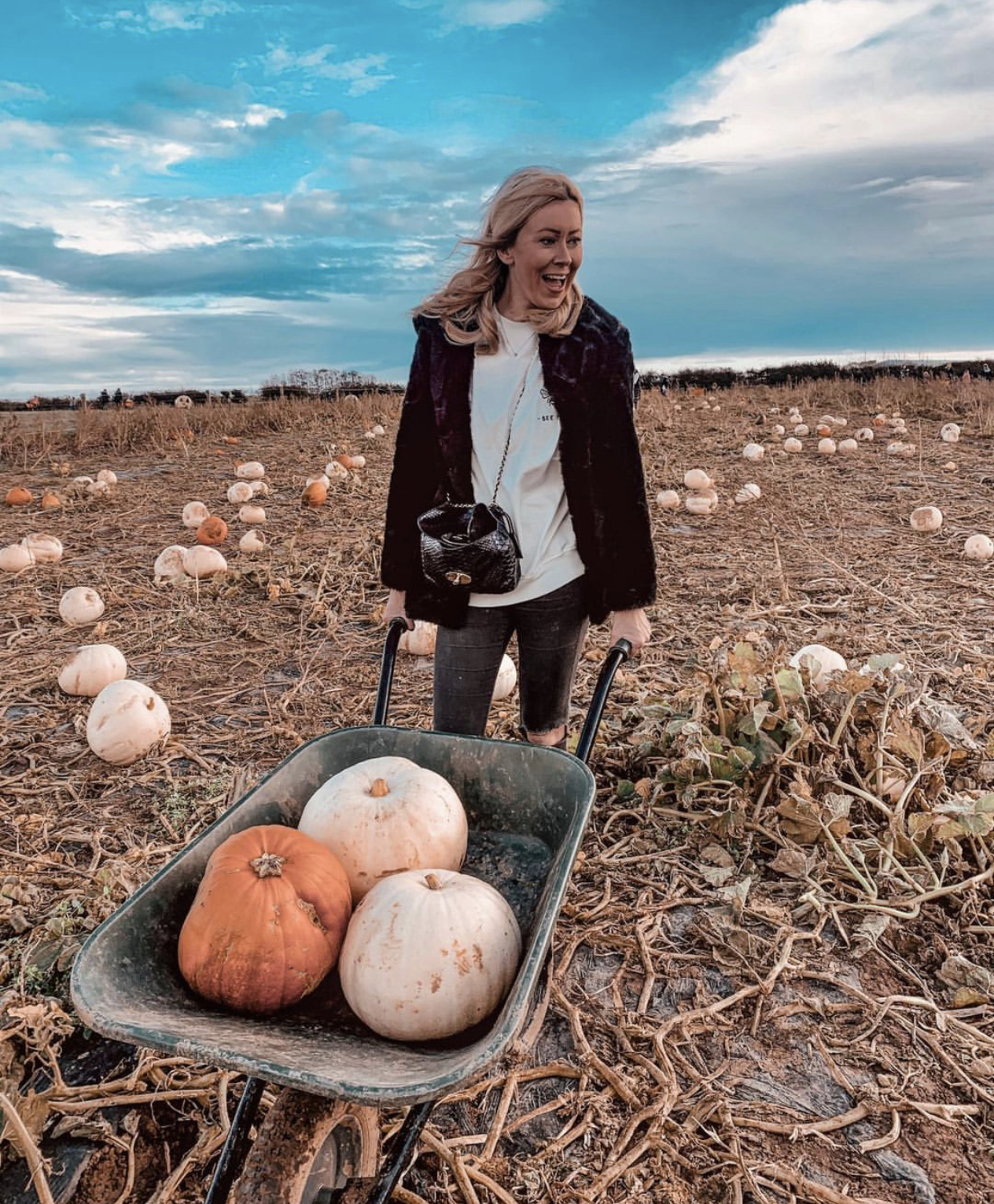 Blonde Lady holding a motivational card reading She believed she could so she did.