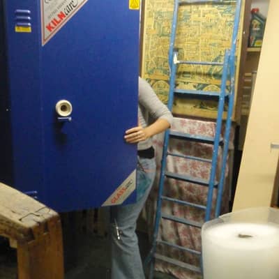 Jessica Irena Smith at work in her glass studio - loading the kiln