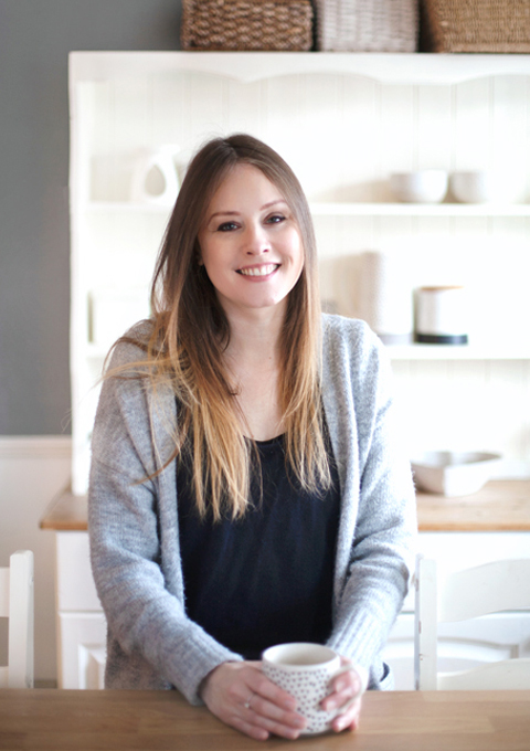 Linda holding a cuppa and smiling 