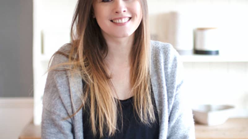 Linda holding a cuppa and smiling