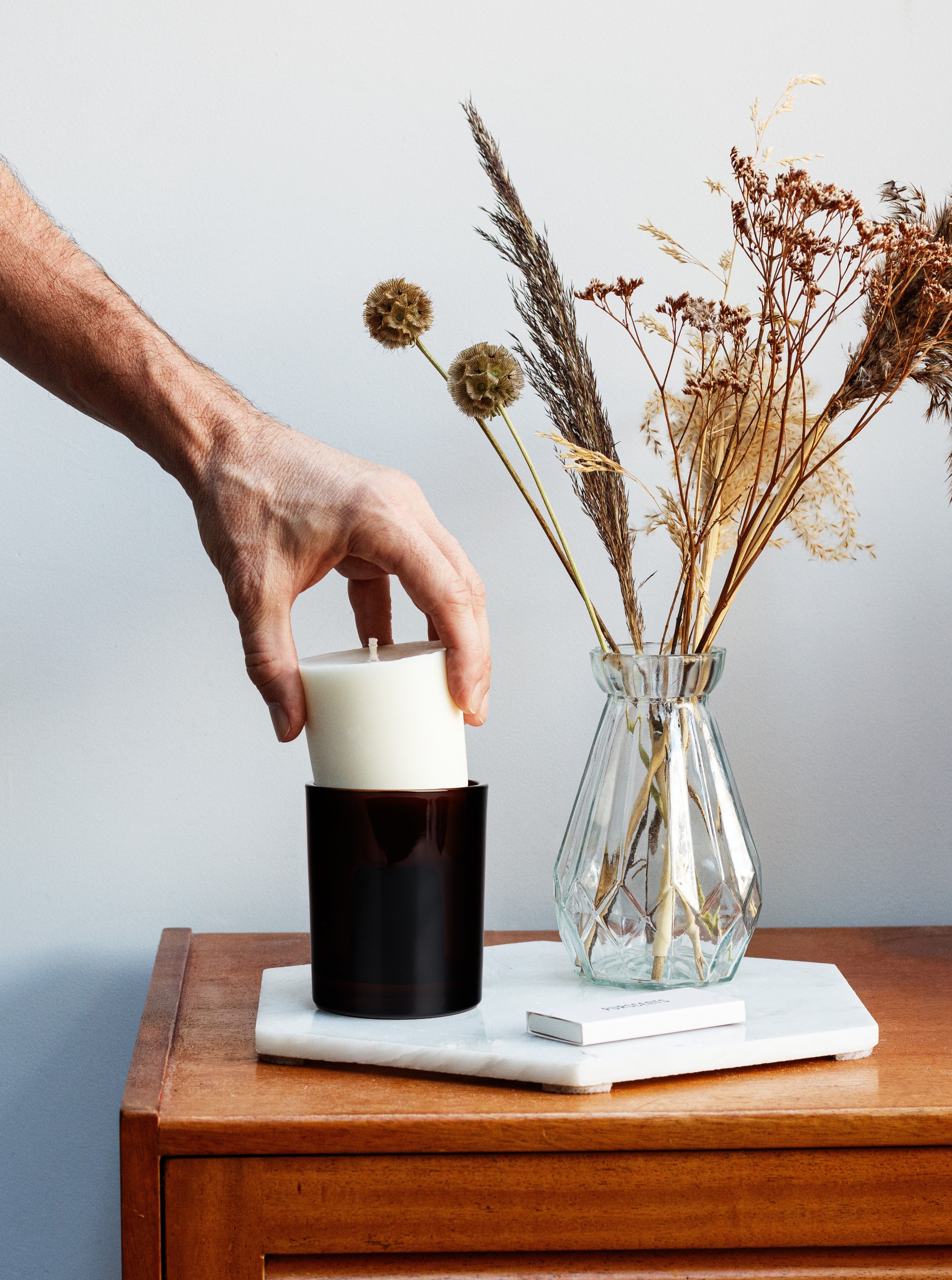 Aromatherapy candle refill being placed in jar