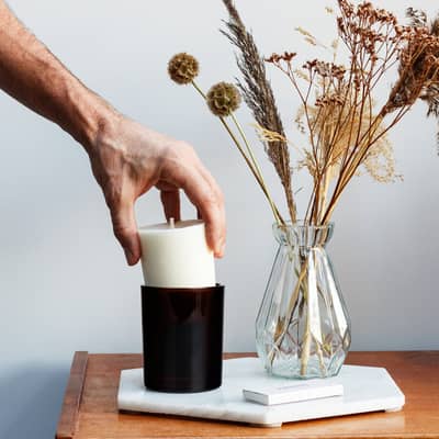 Aromatherapy candle refill being placed in jar