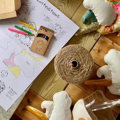 An aerial shot from the workshop looking down on unicorn models and a coloured instructions leaflet.