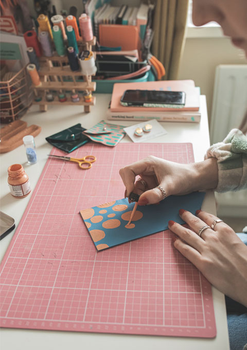 Close up of Jemma painting a card pouch