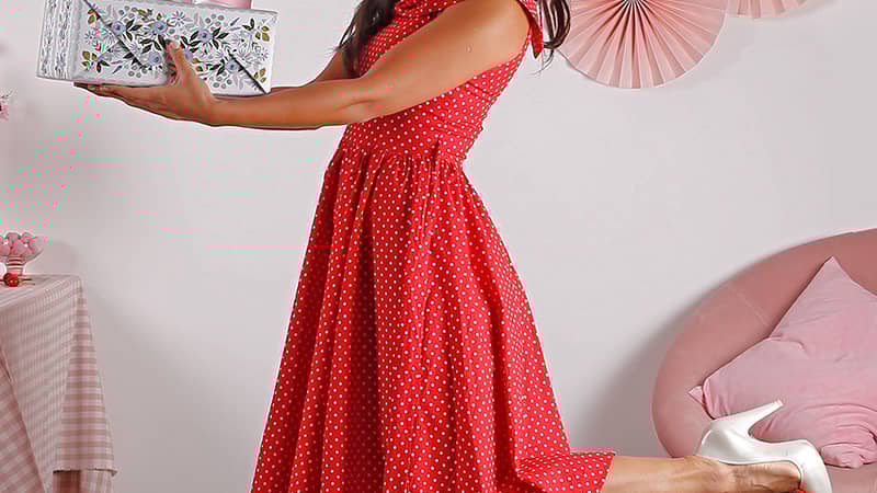 girl holding a pile of making meadows wrapping paper presents