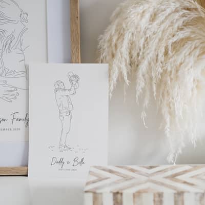 Line drawing portrait of a man kissing the pregnant belly of a woman framed with a vase and light surrounding it