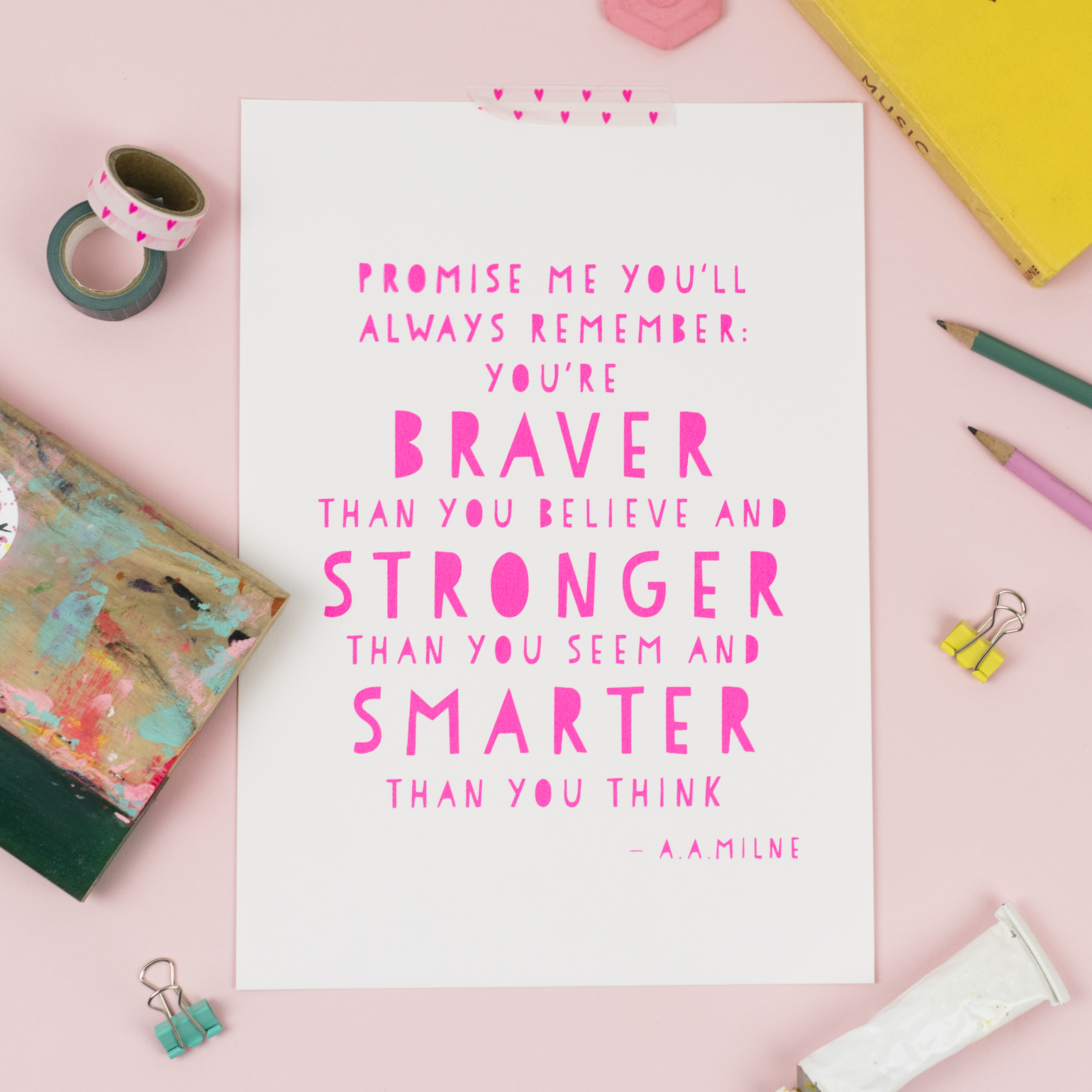 Wooden plaque wall hanging and two colourful prints on a peg board