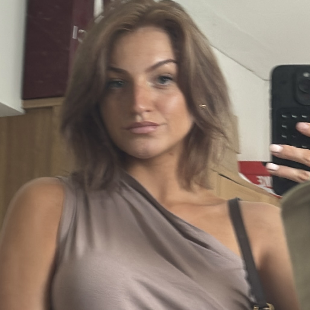 Photo of founder wearing a leather jacket and smiling.